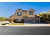 Charming two-story stucco home featuring a three-car garage and well-maintained landscaping at 29 Blue Valley Dr, Henderson, NV 89002
