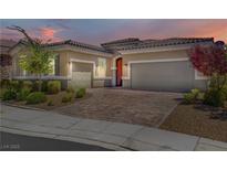 Beautiful home featuring a paver driveway, desert landscaping, and a two-car garage at 3155 Dalmazia Ave, Henderson, NV 89044
