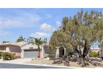 Charming single-story home with desert landscaping, mature tree, and two-car garage at 4227 Pacifico Ln, Las Vegas, NV 89135
