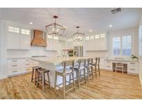 Bright, modern kitchen features a large island with seating, stainless steel appliances, and ample cabinet space at 5434 Fawn Chase Way, Las Vegas, NV 89135