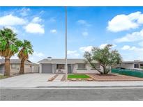 Charming single-story home with a well-manicured front yard, mature landscaping, and a spacious driveway at 721 Carpenter Dr, Las Vegas, NV 89107