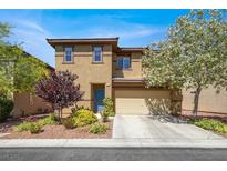 Charming two-story home with a two car garage, landscaped front yard, and blue front door at 7931 Mineral Peak St, Las Vegas, NV 89166