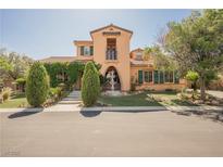 Charming two-story home with landscaped yard and a decorative water fountain at 7947 Lookout Rock Cir, Las Vegas, NV 89129