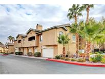 Inviting multi-level home showcasing beautiful desert landscaping and an attached two-car garage at 8725 Red Rio Dr # 203, Las Vegas, NV 89128