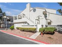 Charming stucco condo with a private balcony, red rock landscaping, and well-maintained front yard at 8932 Antioch Way, Las Vegas, NV 89117