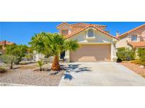 Charming two-story home featuring a tile roof and well-maintained landscaping with desert accents at 9408 Amber Valley Ln, Las Vegas, NV 89134