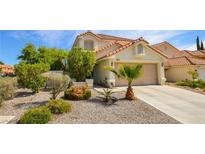 Inviting single-Gathering home featuring desert landscaping, a two-car garage and a traditional roof at 9408 Amber Valley Ln, Las Vegas, NV 89134