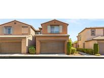 Charming two-story house featuring a two-car garage, neutral stucco and shutters at 11398 Belmont Lake Dr # 104, Las Vegas, NV 89135