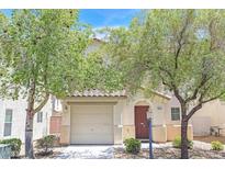 Charming single-Gathering home featuring a red front door and a one car garage at 11934 Wild Chamomile St, Las Vegas, NV 89183