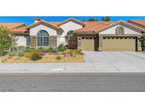 Charming single-story home with a tile roof, stucco exterior, and well-maintained desert landscaping at 1432 Castle Crest Dr, Las Vegas, NV 89117
