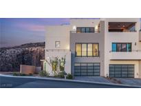 Contemporary three-story home boasting multiple balconies, garage parking, and modern architectural design at 350 Solitude Peak Ln, Henderson, NV 89012