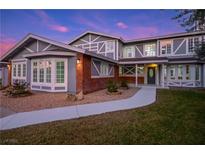 Charming two-story home featuring unique architectural detail and a well-manicured front lawn at 3531 W Arby Ave, Las Vegas, NV 89118
