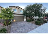 Charming two-story home featuring a well-maintained front yard and brick driveway, complemented by mature trees at 4633 Fragrant St, North Las Vegas, NV 89031