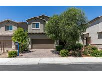 Inviting two-story home features a well-maintained front yard and a brick-paved driveway leading to a two-car garage at 4633 Fragrant St, North Las Vegas, NV 89031