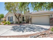 Charming single-story home with a two-car garage, wrought iron gate, desert landscaping, and mature trees at 5017 Kaibab Forest Ave, Las Vegas, NV 89141