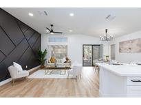Bright living room featuring a modern decor, luxury furniture, and dark accent wall at 502 Edgefield Ridge Pl, Henderson, NV 89012