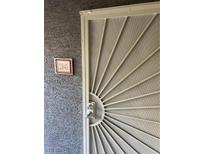 Apartment 2041 front door with a decorative security screen and modern lockset at 5055 W Hacienda Ave # 2041, Las Vegas, NV 89118