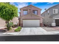 Charming two-story home with a two-car garage and well-maintained front yard landscaping at 5321 Welch Valley Ave, Las Vegas, NV 89131