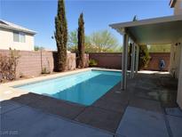 Backyard pool with mature landscaping and covered patio for relaxing on hot days at 6604 Octave Ave, Las Vegas, NV 89139