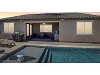 Beautiful backyard with a private pool and covered patio area, perfect for entertaining at 716 Cadence View Way, Henderson, NV 89011
