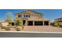 Beautiful two-story home showcasing a three-car garage and a well-maintained desert landscape at 7572 Mount Spokane Ct, Las Vegas, NV 89113