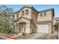 Charming two-story home featuring a tile roof, stucco siding, and a well-manicured front yard, plus an attached garage at 765 Jewel Tower St, Las Vegas, NV 89178