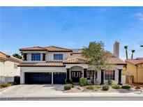 Charming two-story home with a three car garage and nicely landscaped front yard at 8713 Castle Ridge Ave, Las Vegas, NV 89129