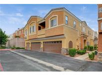 Inviting two-story townhome featuring a two-car garage and well-maintained landscaping at 9303 Gilcrease Ave # 1056, Las Vegas, NV 89149
