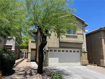 Two-story home featuring a stucco facade, well-maintained landscaping, and an attached two-car garage at 9452 Plover Falls Ave, Las Vegas, NV 89149