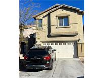 Charming two-story home with a two-car garage and well-kept driveway and a car parked in front at 9452 Plover Falls Ave, Las Vegas, NV 89149
