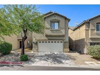 Inviting home featuring a two-car garage, drought-resistant landscaping, and a mature shade tree at 9452 Plover Falls Ave, Las Vegas, NV 89149