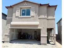 Two-story tan home featuring an attached two-car garage and unfinished landscaping at 10400 Luna Mezzo St Ave # Lot 193, Las Vegas, NV 89141
