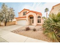 Charming two-story home with a tile roof and stucco exterior, plus a low-maintenance desert-style front yard at 1604 Tamborine Ct, Las Vegas, NV 89128