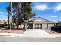 Charming single-story home with a two-car garage, palm tree, and well-maintained front yard at 1878 Corvette St, Las Vegas, NV 89142