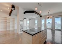 Modern kitchen with center island, stainless steel appliances and cityscape view at 200 Hoover Ave # 1905, Las Vegas, NV 89101