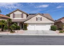 Charming two-story home with a well-manicured front yard and a two-car garage in a residential neighborhood at 2383 Thayer Ave, Henderson, NV 89074