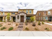 Charming two-story home with stone accents and desert landscaping, steps up to the front door at 3270 Palindrome Ave, Henderson, NV 89044