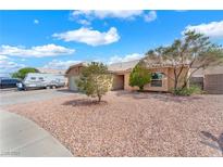 Single-story home featuring a gravel yard, attached two-car garage and an RV parked on the side at 503 Credence Ave, Henderson, NV 89002