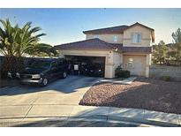 Two-story home featuring desert landscaping, and an attached two-car garage at 6024 Ripple Cloud Ct, North Las Vegas, NV 89031