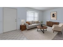Bright living room with large bay window, neutral furniture, and stylish decor at 875 Rhinegold Way, Las Vegas, NV 89110