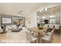 Bright living room boasts an open floor plan, neutral decor and ample natural light at 10309 Georgetown Pl, Las Vegas, NV 89134