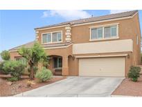 Attractive two-story home featuring a two-car garage and well-maintained landscaping at 1405 Peyton Stewart Ct, North Las Vegas, NV 89086