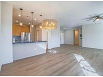 Bright living room featuring wood floors, and an open floor plan adjacent to a modern kitchen at 1510 Fieldbrook St, Henderson, NV 89052