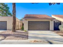 Charming single-story home featuring a brown garage door and a well-maintained, neutral-toned exterior at 1850 Camino Verde Ln, Las Vegas, NV 89119