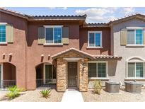 Charming two-story townhouse featuring a stone-accented entrance and a well-maintained, xeriscaped front yard at 25 Barbara Ln # 36, Las Vegas, NV 89183