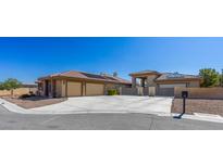 Expansive single-story home showcasing a neutral color palette, complemented by a spacious driveway and well-manicured landscaping at 271 E Shelbourne Ave, Las Vegas, NV 89123
