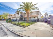 Charming home with a well-manicured lawn, mature palm tree, wrought iron fence, and inviting curb appeal at 3617 Dutch Valley Dr, Las Vegas, NV 89147
