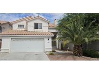 Two-story home with white facade, two-car garage, tile roof and desert landscaping at 3750 Morning Canyon St, Las Vegas, NV 89147