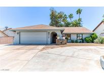Charming single-story home featuring a two-car garage, desert landscaping, and a welcoming front entrance at 4381 Toledo Ave, Las Vegas, NV 89121