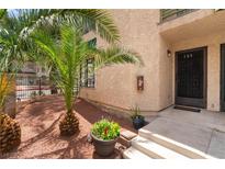 Inviting condo entrance with well-maintained landscape and unit number displayed above decorative security door at 440 Elm Dr # 103, Las Vegas, NV 89169